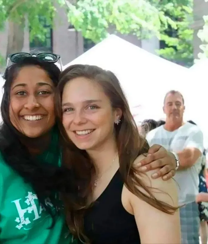 Optical illusion photo of a man in the background appearing to rest his hand on a woman's shoulder.