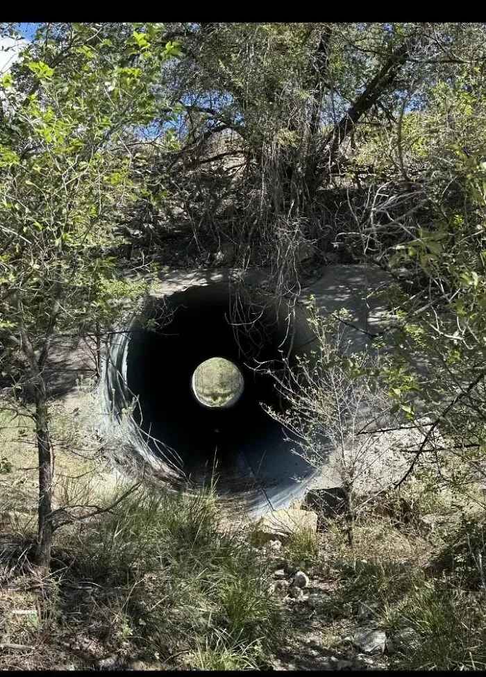 A drainage pipe optical illusion creating a confusing perspective photo.