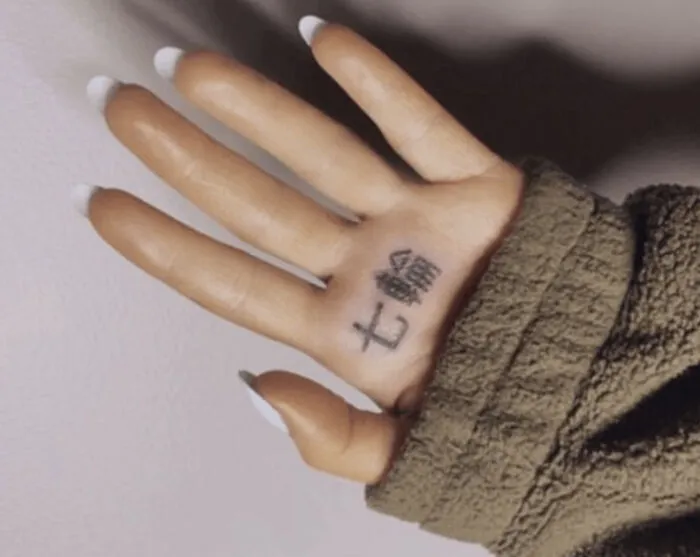 Ariana Grande palm tattoo in Japanese characters, a widely known celebrity social media fail.