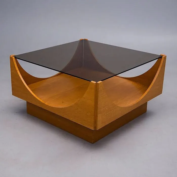 A mid-century modern coffee table made of glass and clever wooden creations.