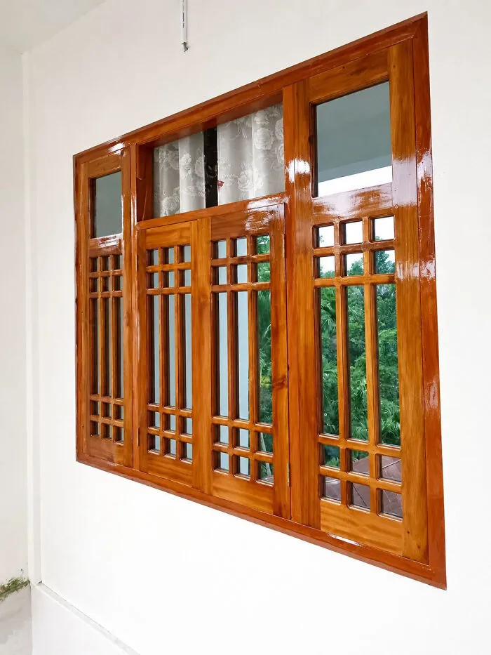 Beautifully polished teak window frames, illustrating clever wooden creations.
