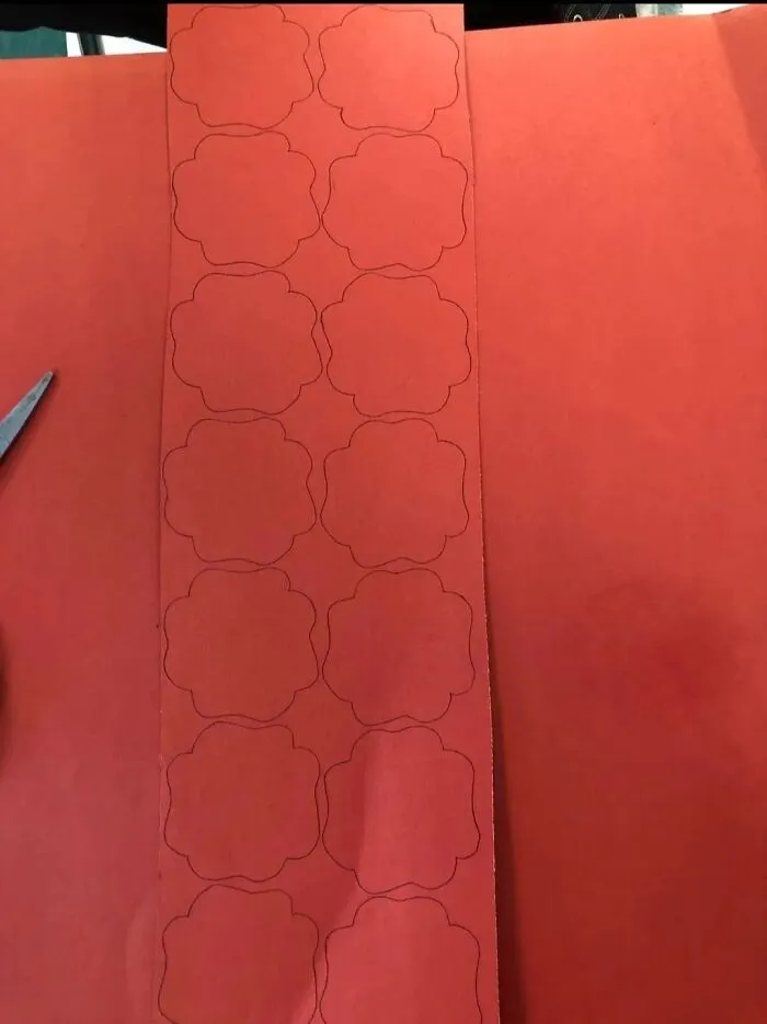 Red paper craft cutout creating a confusing perspective optical illusion.
