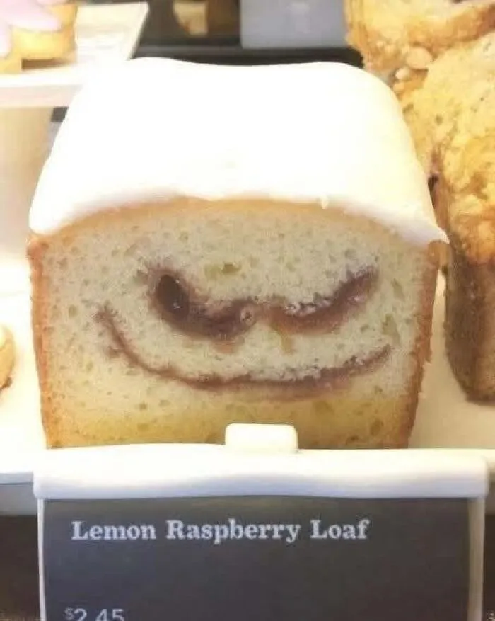 Lemon raspberry loaf slice with a swirl that resembles a smiling face