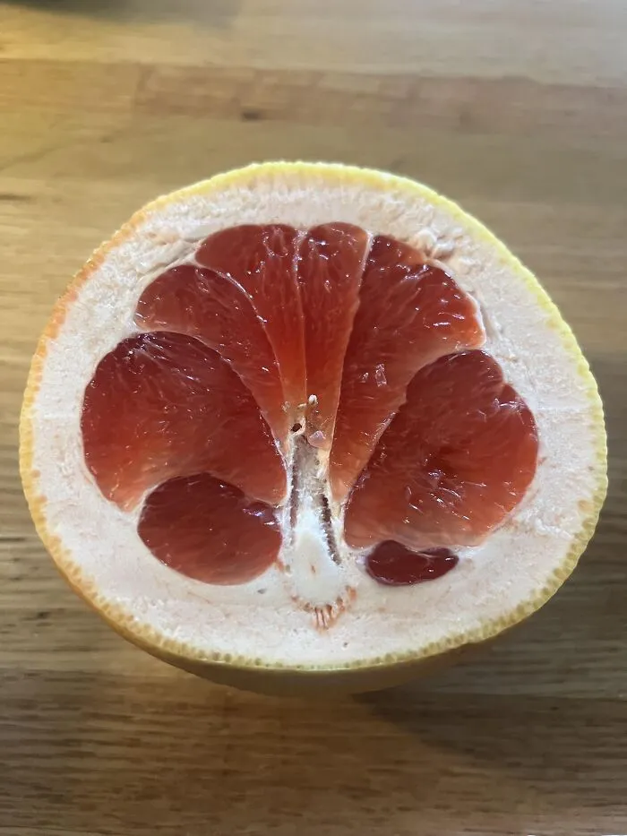 A grapefruit slice resembling a face, showing how photos make you wonder if your eyes play tricks