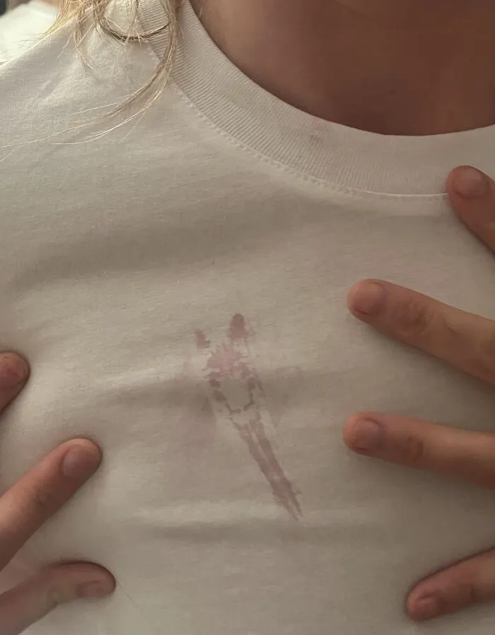 A photo of a stain on a white shirt that looks like a giraffe head