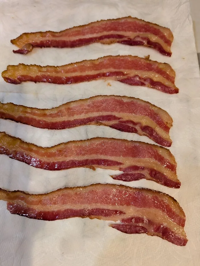 Strips of raw bacon aligned, making your eyes play tricks on you