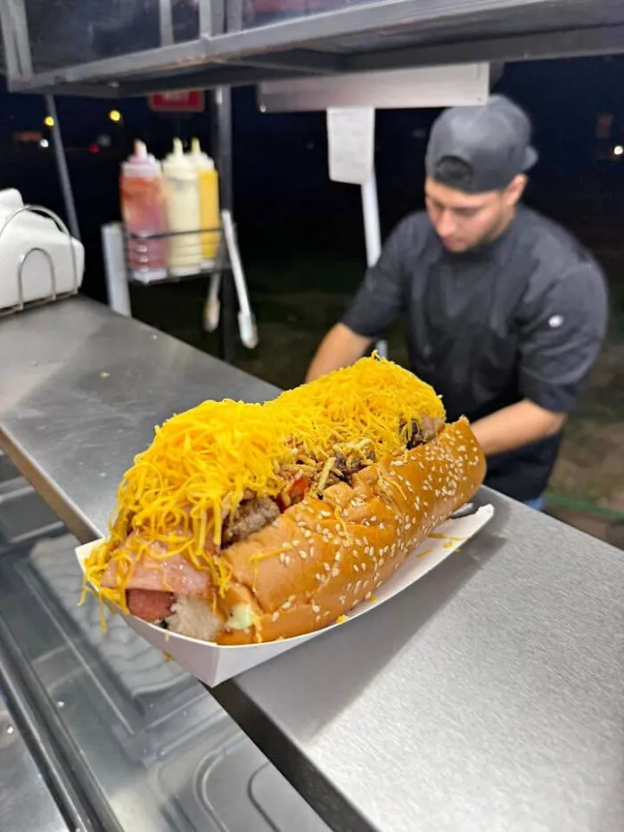A giant loaded hotdog sandwich visual perspective trick that makes your eyes play tricks.