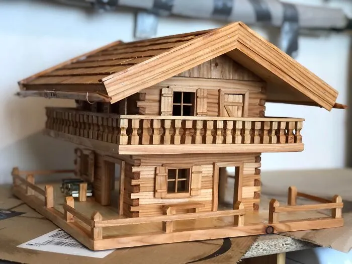 A detailed miniature log cabin showing clever wooden creations