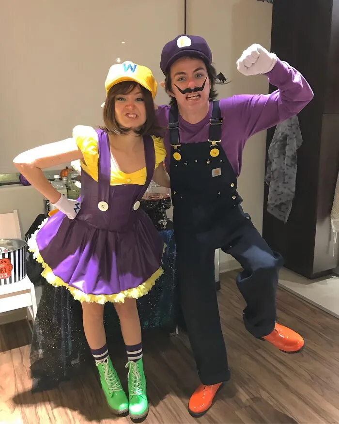 A couple dressed in purple and yellow Mario character outfits for funny Halloween couples costumes.