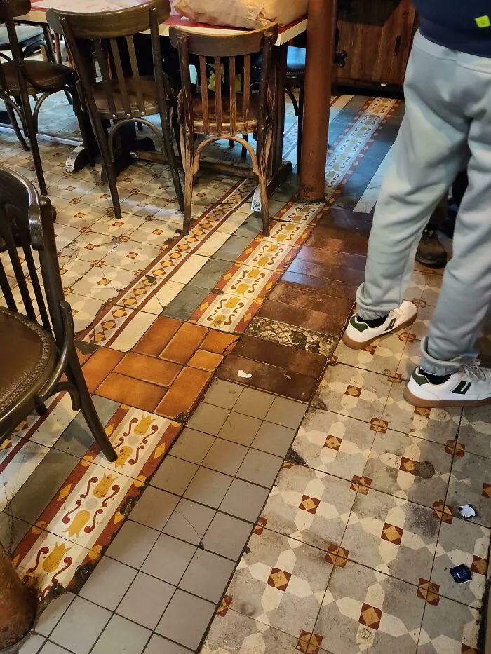 An eclectic floor made from mismatched decorative tiles demonstrating creativity.