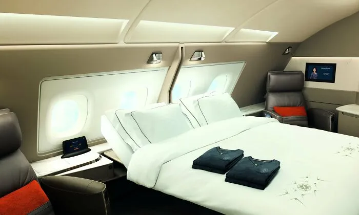 Luxurious first class airplane suite with a double bed showing ingenious things from around the world