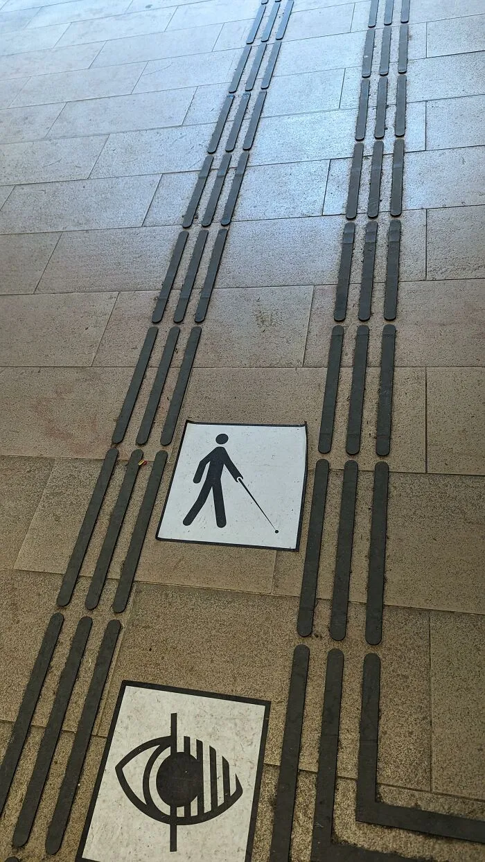 Tactile paving on a sidewalk for the visually impaired, an example of useful design