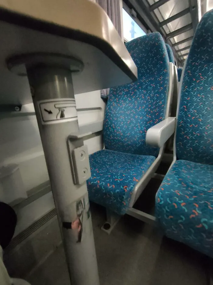 Train seat with built in bag hook showing ingenious things around the world