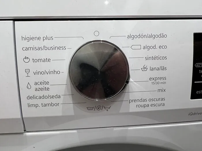 Close-up of a washing machine dial with specific wash cycles written in Spanish, representing useful and ingenious things.