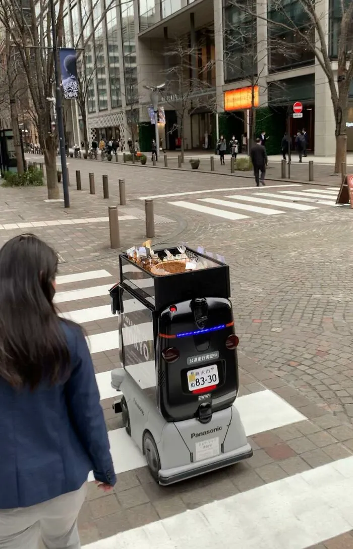 Autonomous delivery robot crossing a street in Japan, an example of useful and ingenious things in various parts of the world.