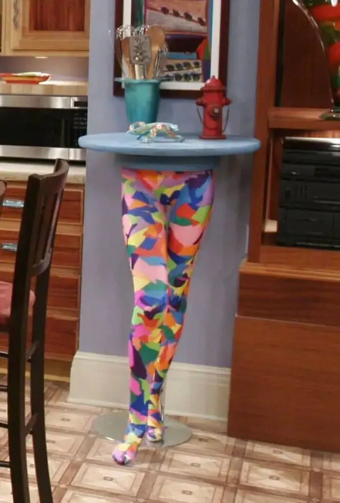 A colorful table shaped like legs used as movie props on a TV show