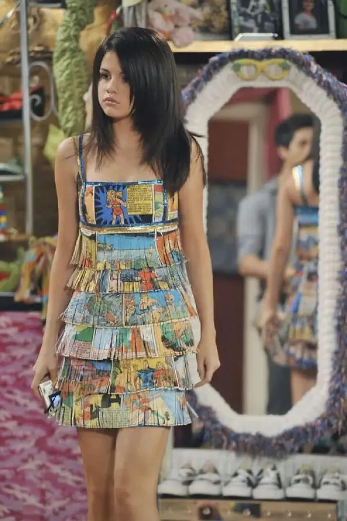 Selena Gomez wearing a comic book dress as iconic movie props on set
