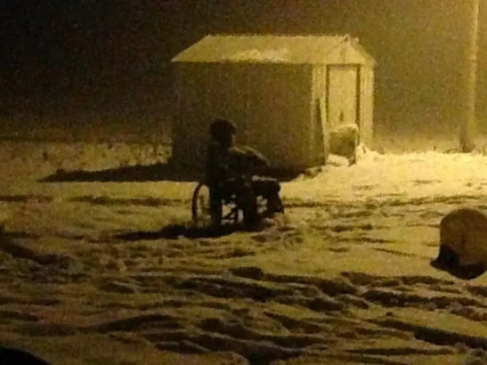 A silhouette of a figure in a wheelchair in snow from creepy photos