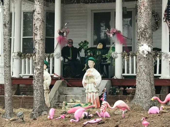 An unsettling front porch filled with strange mannequins and decorations from creepy photos.
