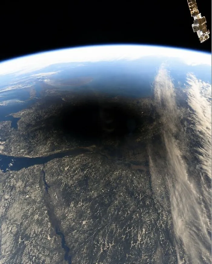 Dark shadow of a solar eclipse on Earth seen from space, among creepy photos.