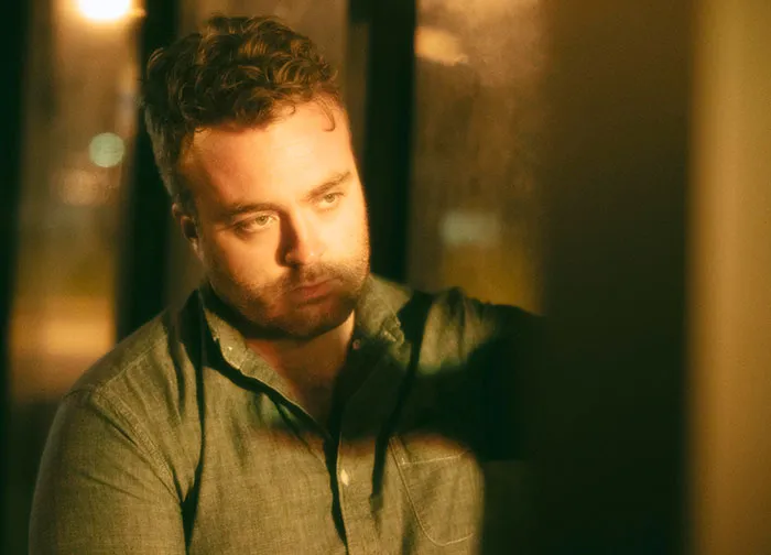 A worried young man looking away thoughtfully as if facing a worst-case scenario.