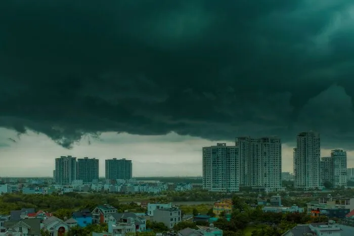 Dark storm clouds over city buildings evoking chilling stories of sensing danger