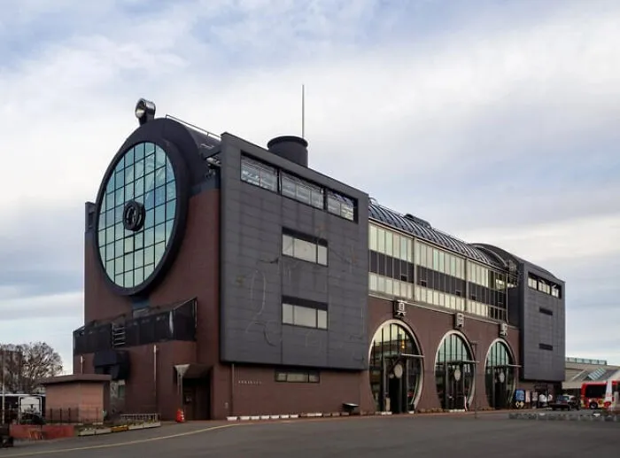 Unusual building with a large circular window and industrial design elements