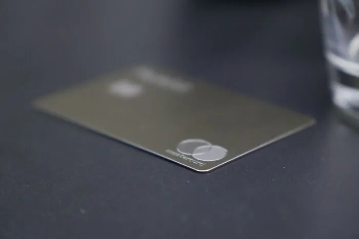A credit card resting on a dark surface, representing financial control by narcissistic parents.