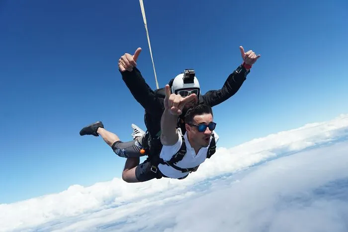 Skydivers mid-air during a tandem jump capturing a thrilling moment