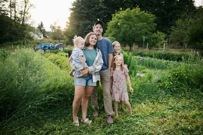 A family standing together outdoors near a garden, reflecting on complex infidelity stories and personal relationships.