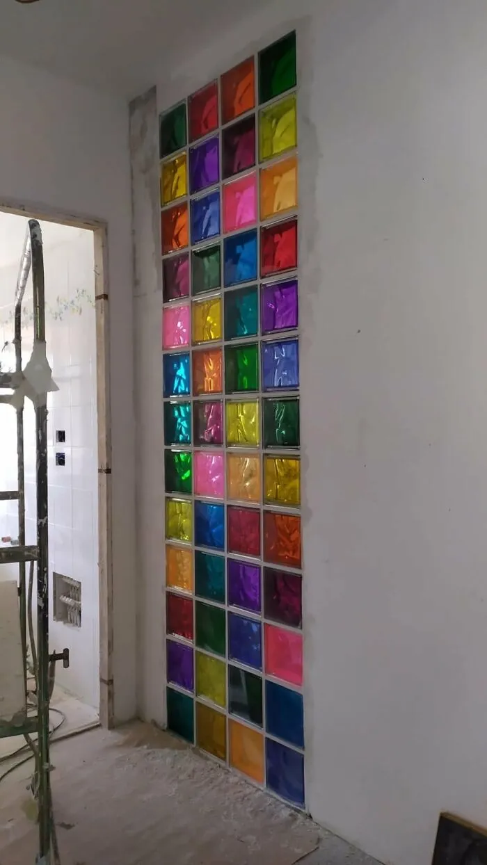 A home makeover featuring a vertical wall section built with colorful stained glass blocks