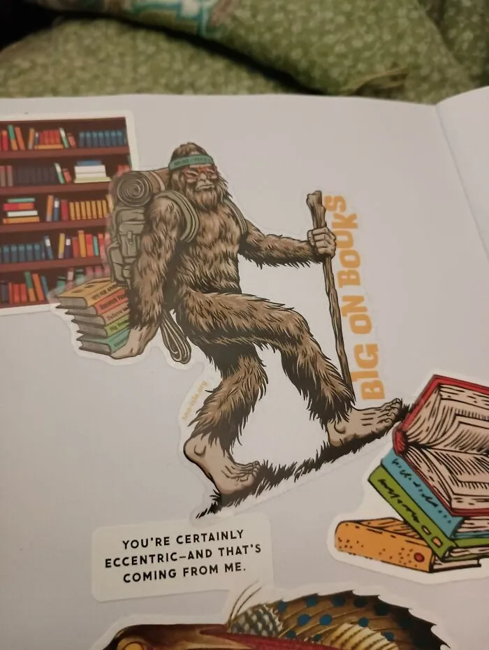 A Bigfoot sticker holding a stack of books on a journal page representing a unique found paper note.