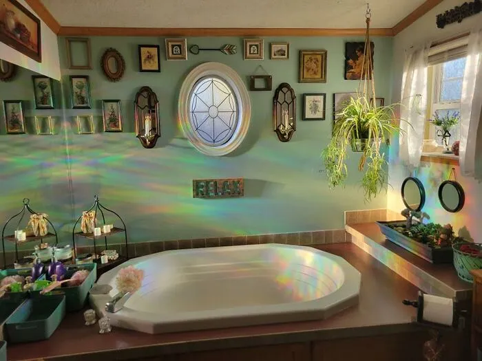Relaxing bathroom home makeover featuring an oval bathtub surrounded by light refractions and plants