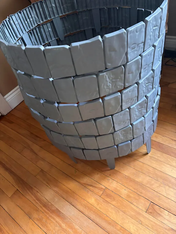 A DIY stone wall prop structure for haunting home Halloween displays.