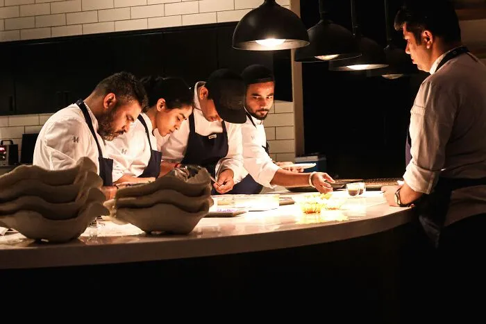 Chefs working together in a commercial kitchen preparing gourmet dishes as part of memorable PR stunts.