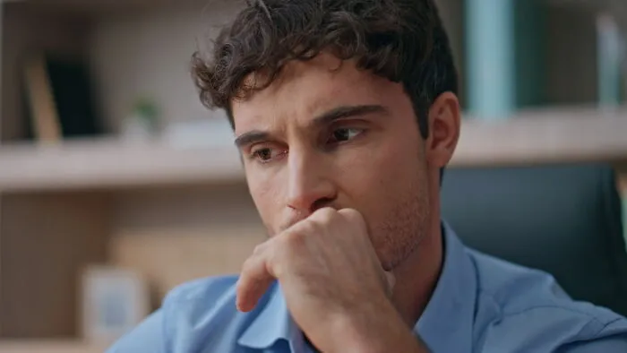 A worried man thinking deeply about advice for divorced people before marriage.
