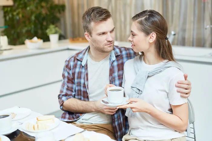 A young couple talking over coffee before their wedding