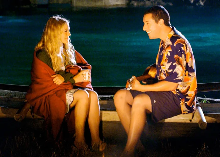 Adam Sandler playing a ukulele for Drew Barrymore outdoors at night