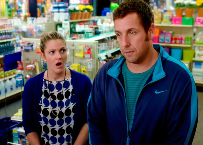 Adam Sandler looking surprised alongside Drew Barrymore in a movie scene