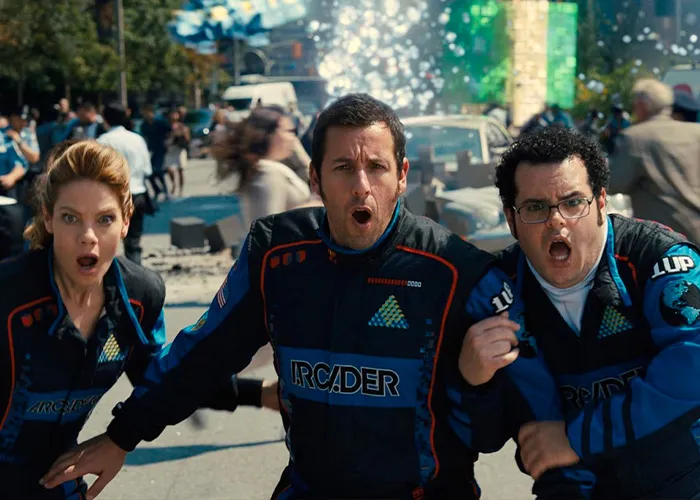 Adam Sandler looking shocked alongside co-stars on a movie set scene