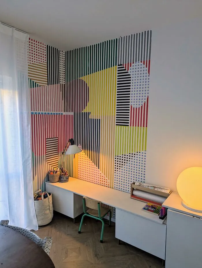 Creative home makeover featuring a bold geometric accent wall in a modern study area.