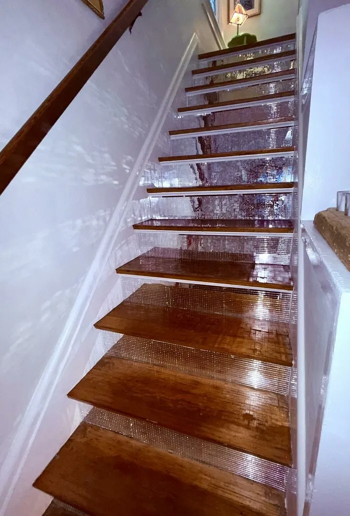 Wooden staircase makeover with reflective mirrored mosaic risers