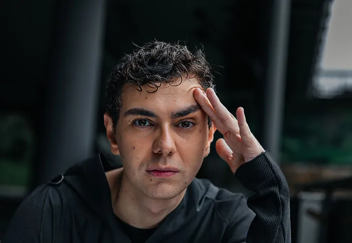 A worried man holding his hand to his head after visiting someone's home