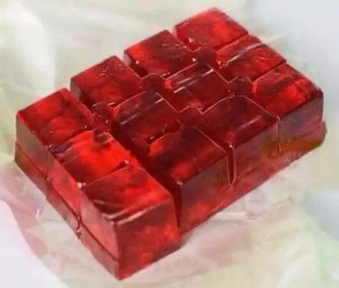A photo of classic red gelatin dessert cubes representing nostalgic 80s kids food.