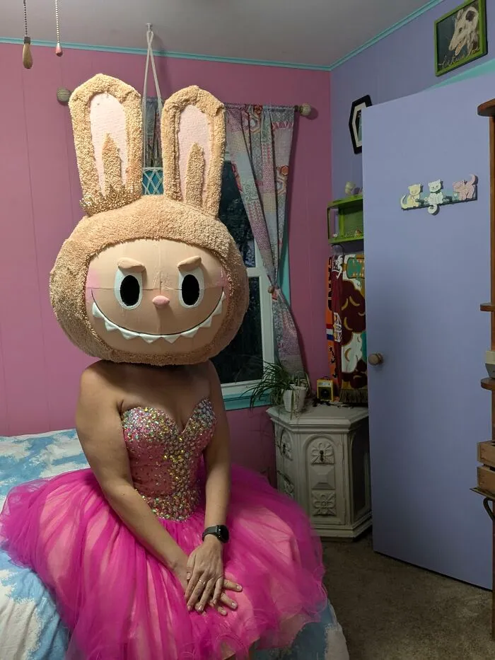 A person wearing a pink gown and a giant bunny head for creative Halloween costume ideas.