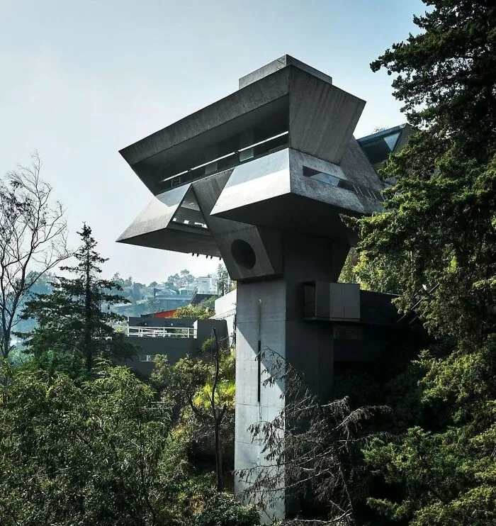 Unique strange building with angular concrete design in forested area
