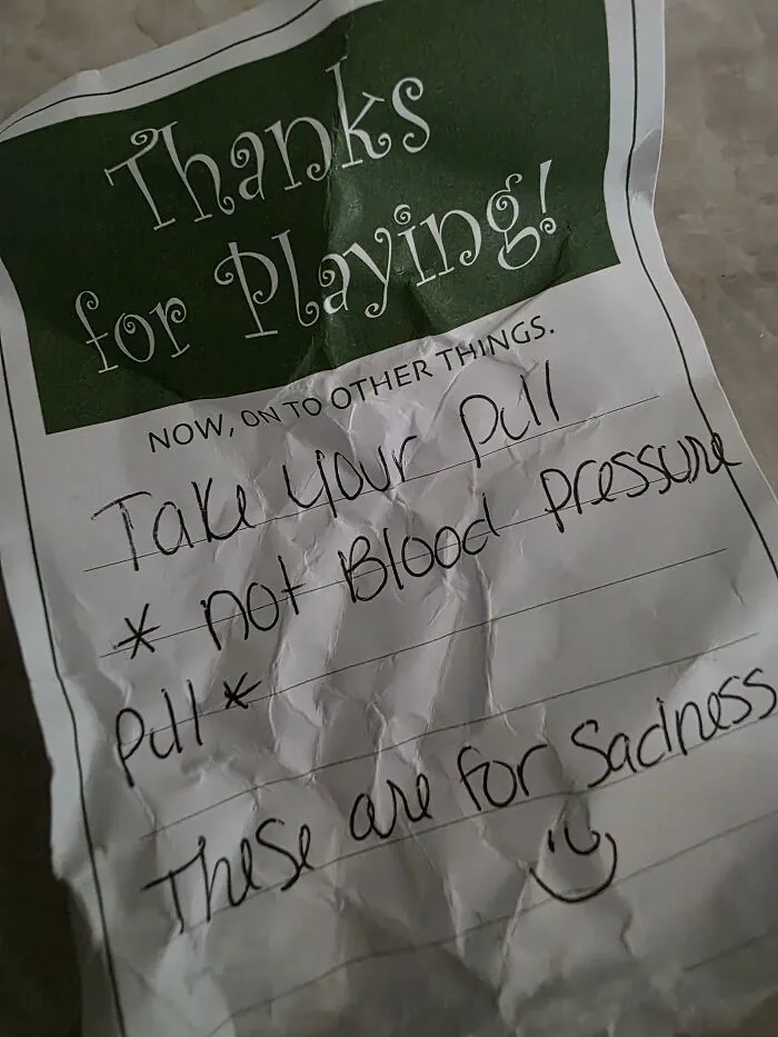 A crumpled found paper note about taking medication and sadness.