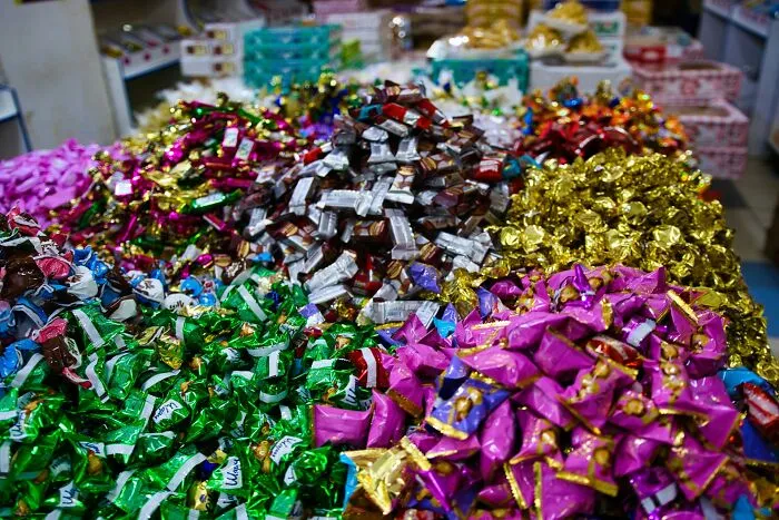 Colorful wrapped candies piled up in a store display