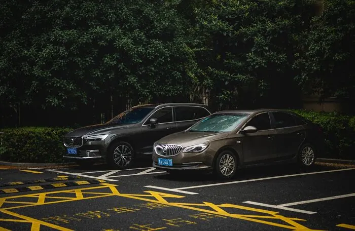 Two cars parked in a lot, representing a situation in satisfying revenge stories.