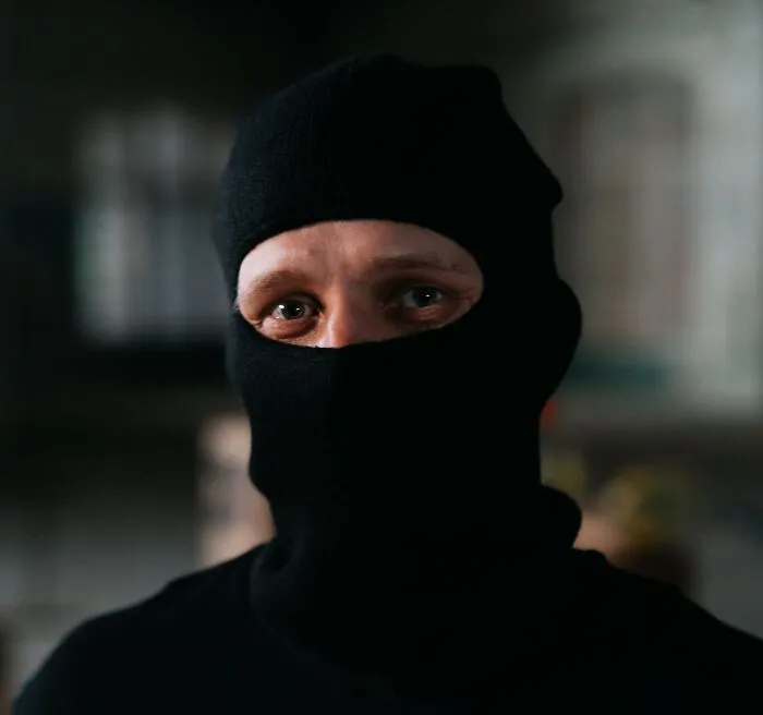 A man wearing a ski mask, illustrating criminal loopholes and strange laws